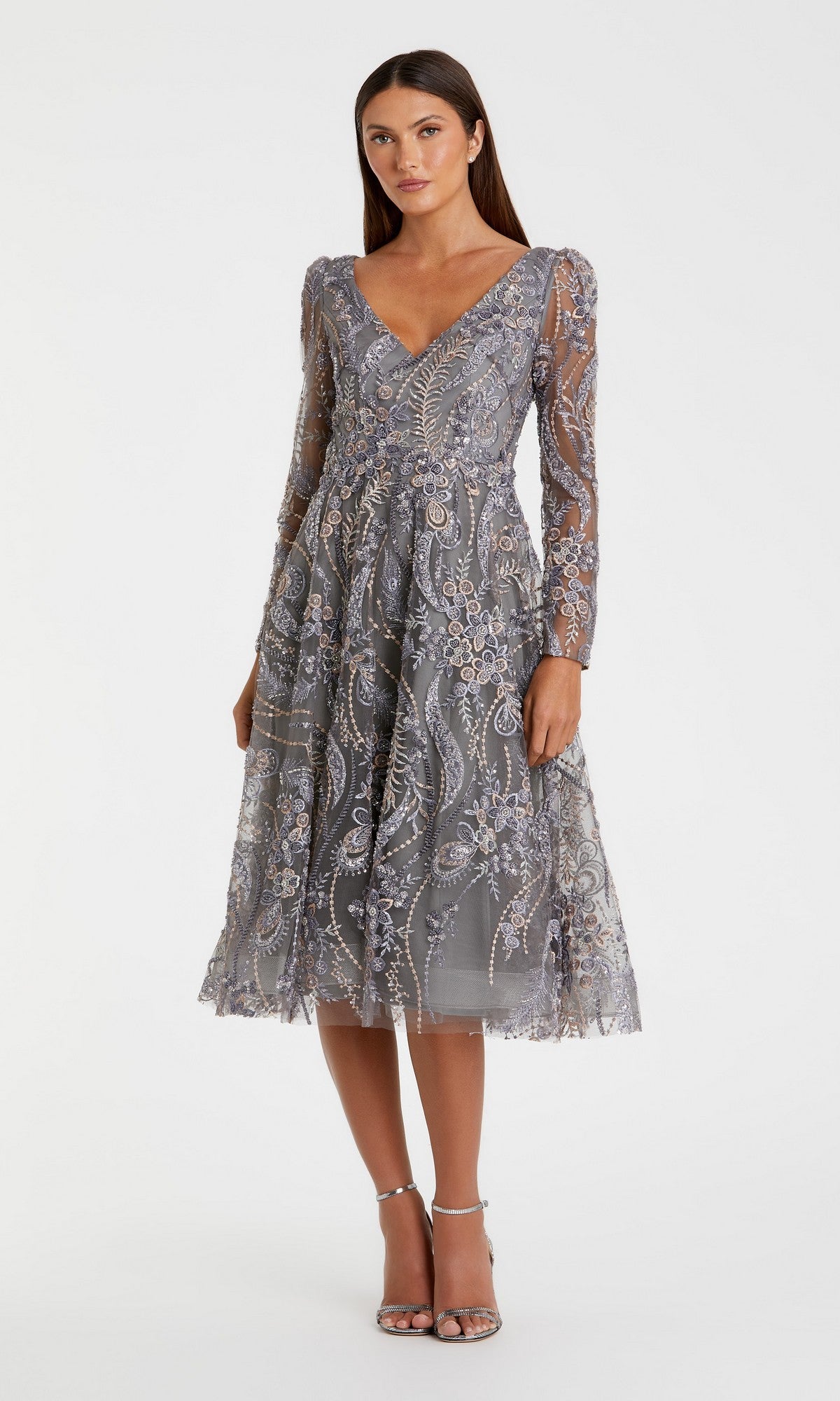 A woman wearing the Mac Duggal 68913 Midi Party Dress in charcoal—a knee-length, long-sleeve dress with intricate lace and bead detailing—stands against a plain white background.